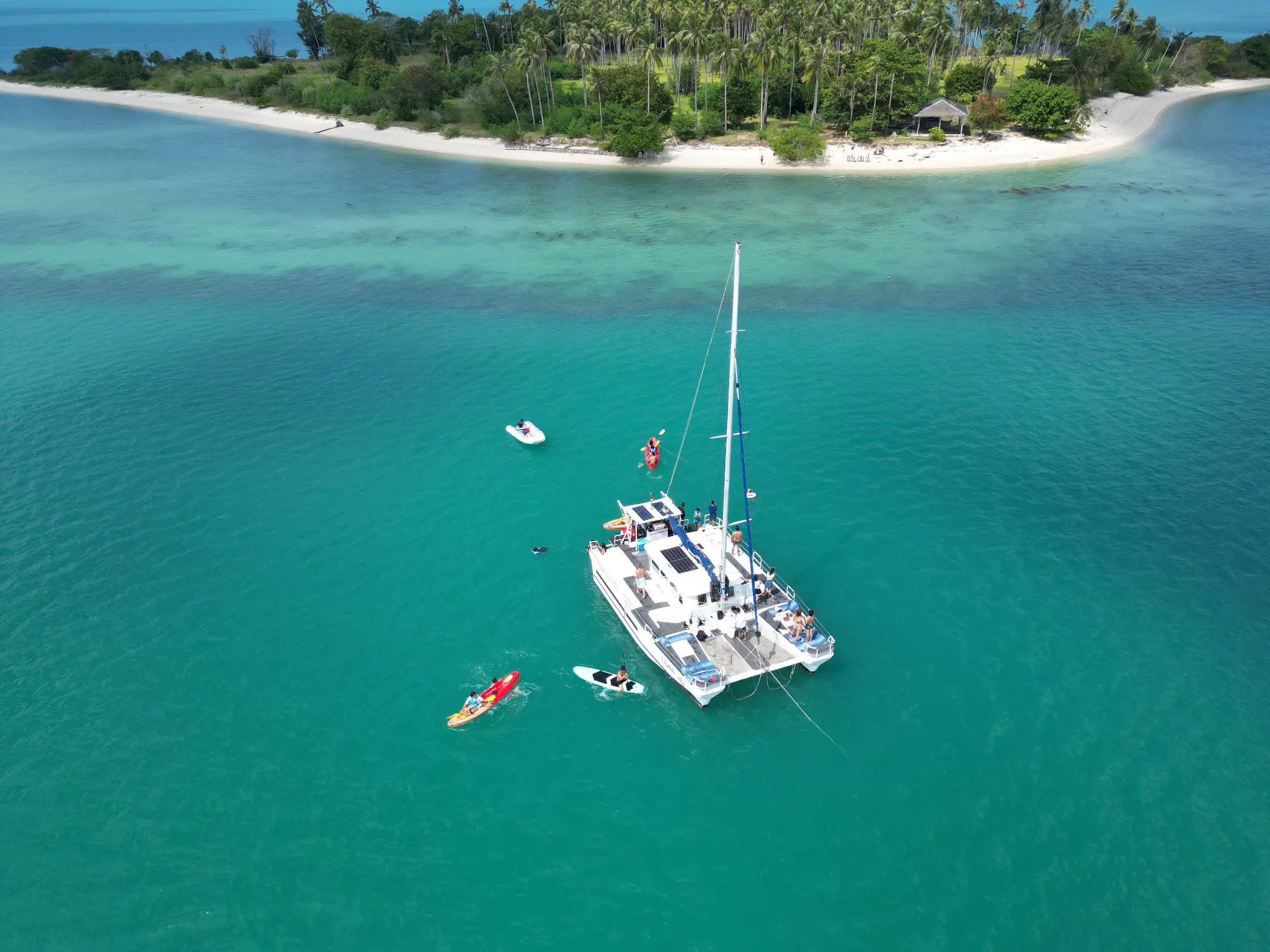Aerial drone view of luxury catamaran in turquoise waters